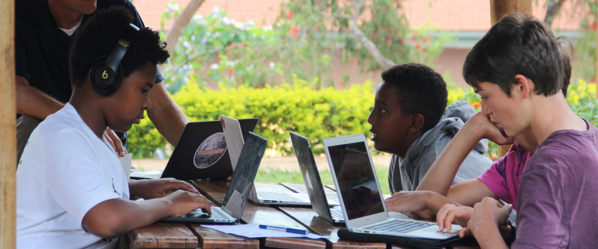 Students working on laptops at the International School of Uganda