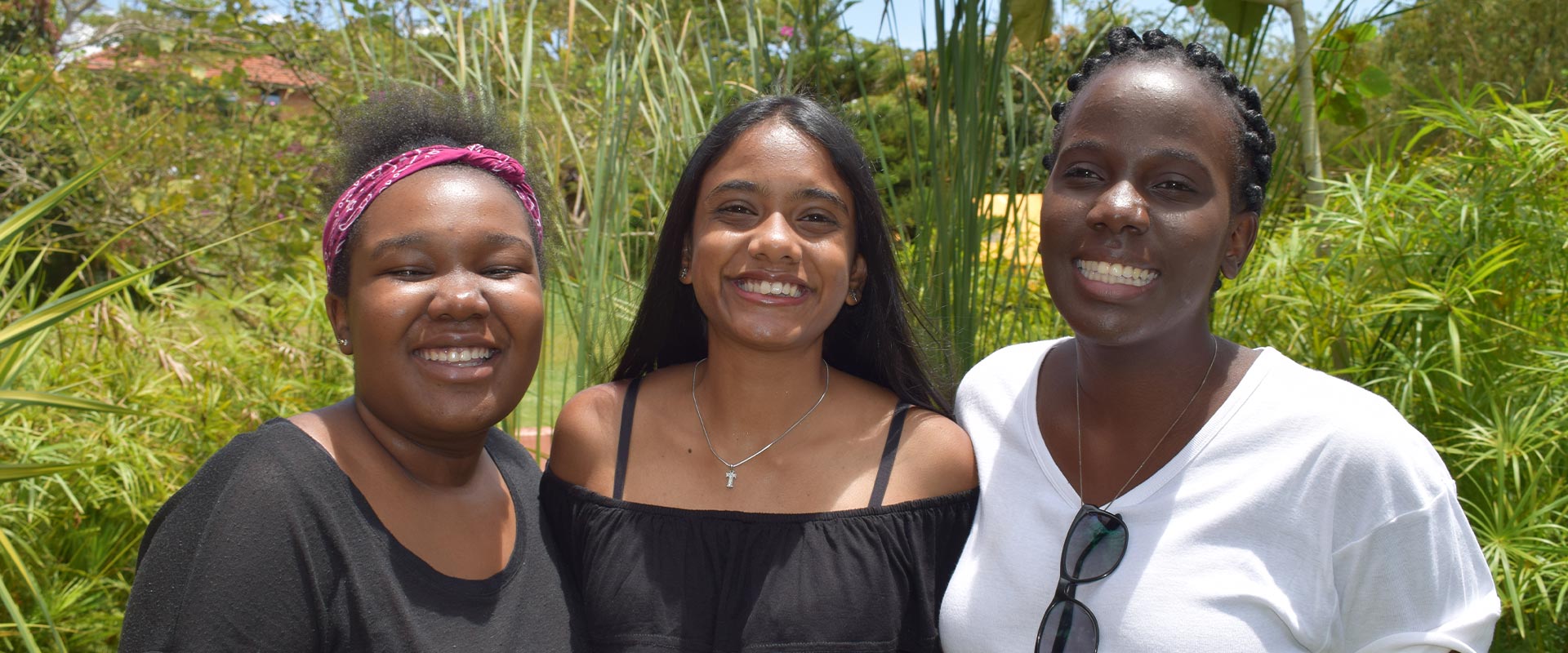 Three ISU alumni stood smiling