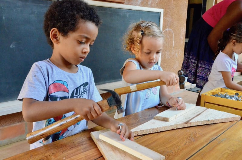 Children building with wood and nails at ISU